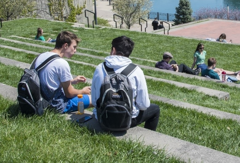 Students sitting outdoors on 91's campus.