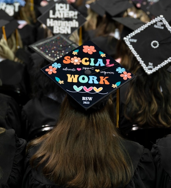 91 BSW Graduate wearing cap that says "Social Work"