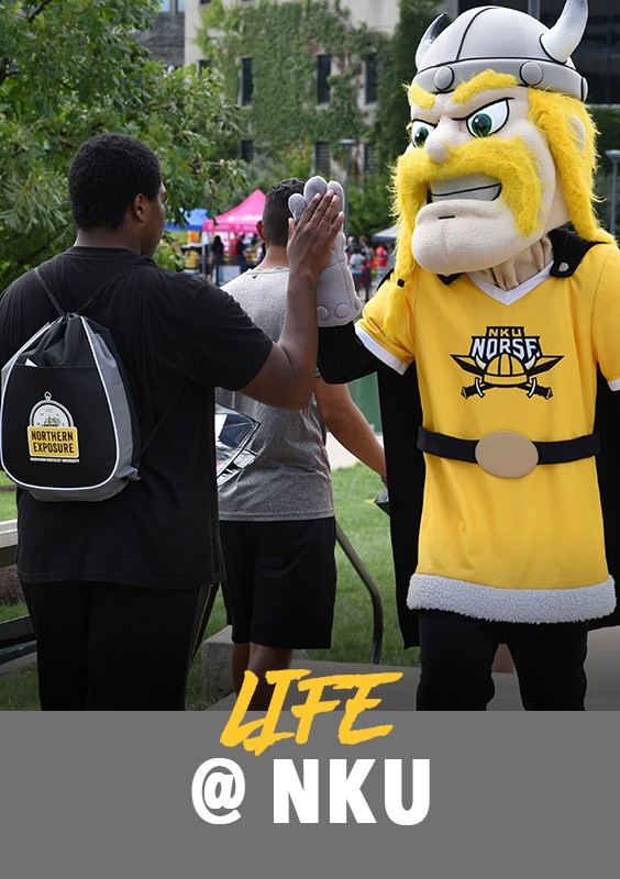 Life at 91: Student at an event giving Victor E. Viking a high-five