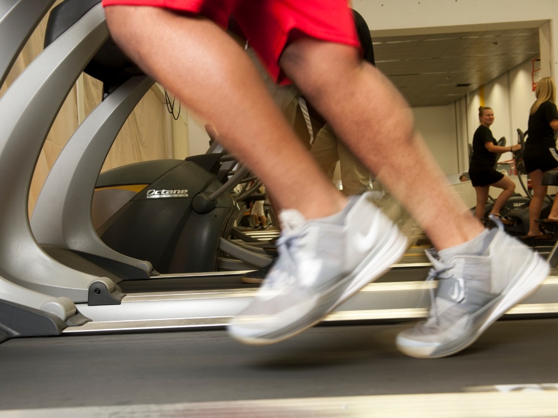 Close-up of a person's legs running on a treadmill.